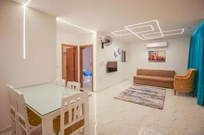 a living room with a table and a couch at La Prestigia in Hurghada