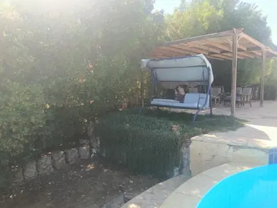 a blue chair sitting under a canopy next to a pool at White villa phase2 - Elgouna 5BD in Hurghada