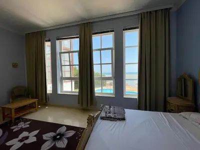 a bedroom with a bed and a large window at White villa phase2 - Elgouna 5BD in Hurghada