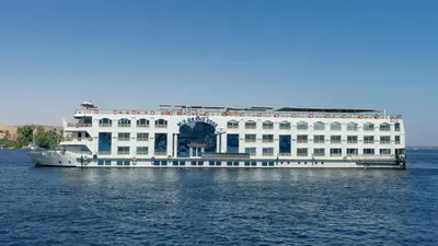 a large white building in the middle of the water at Orient Grand Rose Nile Cruise - Every Saturday from Luxor for 07 & 04 Nights - Every Wednesday From Aswan for 03 Nights in Luxor