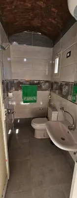 a bathroom with a toilet and a sink at Lale Hoste in Nag` el-Ramla