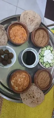 a plate with different types of food on a table at Lale Hoste in Nag` el-Ramla