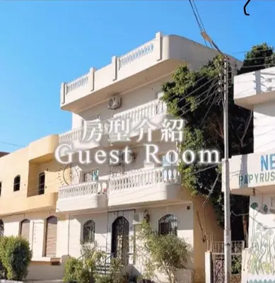 a building with a sign that reads guest room at Continental flat in Al Qurnah