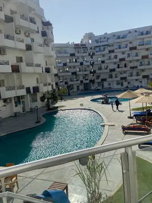 a swimming pool in front of a large building at Tiba view Hurghada in El Gouna