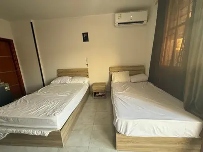 two twin beds in a room withthritisthritisthritisthritisthritisthritisthritisthritisthritis at Tiba view Hurghada in El Gouna