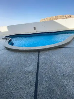 a blue swimming pool on the side of a building at Tiba view Hurghada in El Gouna