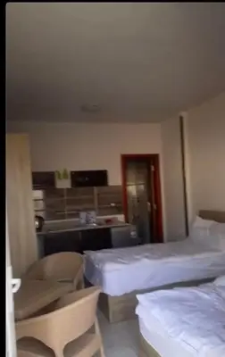 a hotel room with two beds and a desk at Tiba view Hurghada in El Gouna