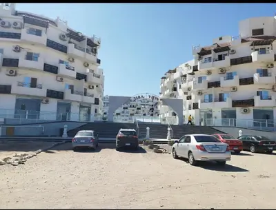 a group of cars parked in a parking lot in front of buildings at Tiba view Hurghada in El Gouna