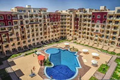 an aerial view of a large apartment complex with a swimming pool at الغردقة كومباوند فلورانزا خمسين in Hurghada