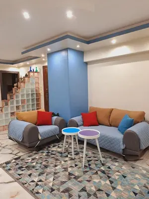 a living room with a couch and two tables at Nile Bride in Naj‘ al ‘Amrāb