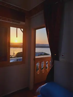 a room with a window with a view of the ocean at Nile Bride in Naj‘ al ‘Amrāb