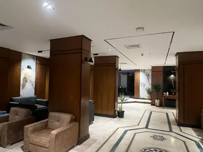 a lobby with couches and chairs in a building at Nuba Nile Hotel in Aswan