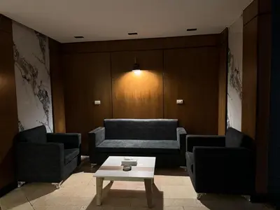 a living room with two couches and a coffee table at Nuba Nile Hotel in Aswan