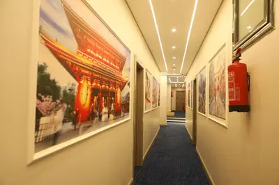 a hallway with paintings on the walls of a building at Nuba Nile Hotel in Aswan