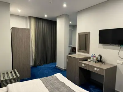 a hotel room with a bed and a flat screen tv at Nuba Nile Hotel in Aswan