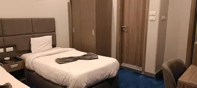 a hotel room with a bed with a robe on it at Nuba Nile Hotel in Aswan