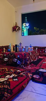 a room with two beds and a window with a lighthouse at MRHostel Luxor in Luxor