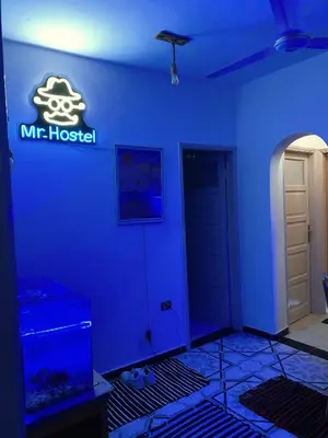 a blue room with amt hospital sign and a fish tank at MRHostel Luxor in Luxor