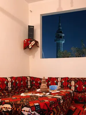 a couch in a living room with a view of a tower at MRHostel Luxor in Luxor