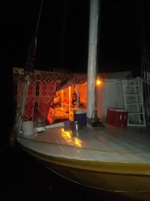 a boat sitting in the water at night at Aswan in Aswan