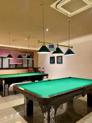 a billiard room with two pool tables and pendant lights at Apartment in el karma aqua beach resort hurghada near el gouna 3 in Hurghada