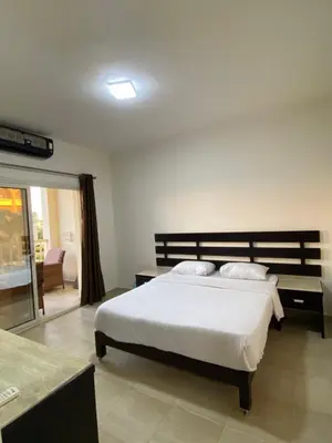 a bedroom with a large white bed in a room at Apartment in el karma aqua beach resort hurghada near el gouna 3 in Hurghada