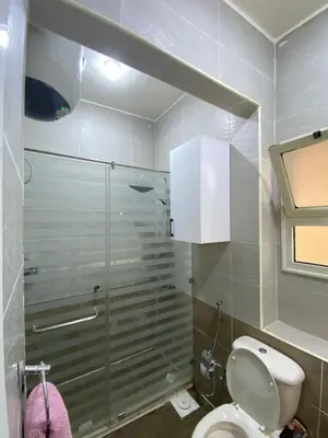 a bathroom with a toilet and a glass shower at Apartment in el karma aqua beach resort hurghada near el gouna 3 in Hurghada