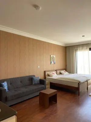 a living room with two beds and a couch at Studil for rent 206 hill in Hurghada