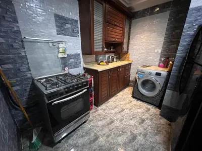 a kitchen with a stove and a washing machine at aswan view 3 bedrooms in Aswan
