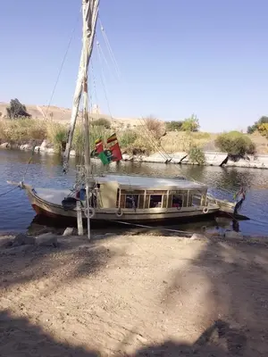 a boat sitting on the side of a river at Sailing spirit in Aswan