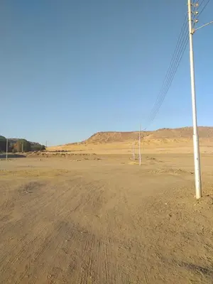 an empty dirt road with a pole in the desert at Mourad morsy مراد in Najâ€˜ al MadÄbb