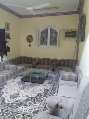 a living room with a couch and a table at Mourad morsy مراد in Najâ€˜ al MadÄbb