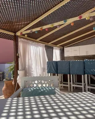 a room with a bed and chairs and a ceiling at Sunny Sea View Studio Marina on private roof in Hurghada