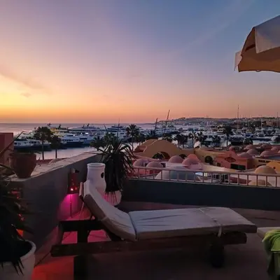 a balcony with a bench and a view of a harbor at Sunny Sea View Studio Marina on private roof in Hurghada