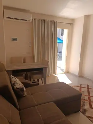 a living room with a couch and a table at Tiba Golden Resort apartment 45 with beach access in Hurghada