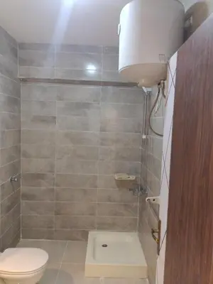 a bathroom with a toilet and a shower at Tiba Golden Resort apartment 45 with beach access in Hurghada