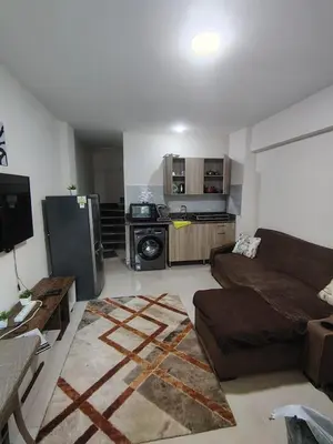 a living room with a couch and a kitchen at Tiba Golden Resort apartment 45 with beach access in Hurghada