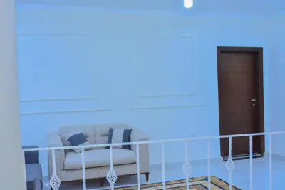 a living room with a couch and a door at king valley House in ‘Ezbet Abu Ḥabashi