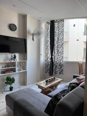 a living room with a couch and a table at Sea Light Apartment in Hurghada