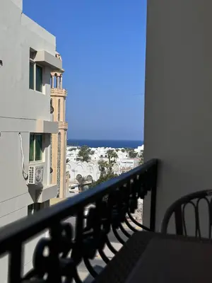 a balcony with a view of a building at Sea Light Apartment in Hurghada