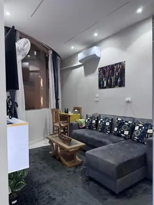 a living room with a couch and a table at Sea Light Apartment in Hurghada