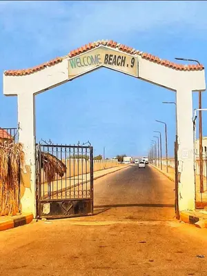 a gate in the middle of a road with a sign at Lux Gardenhouse pool WiFi Private garden Hurghada in Hurghada