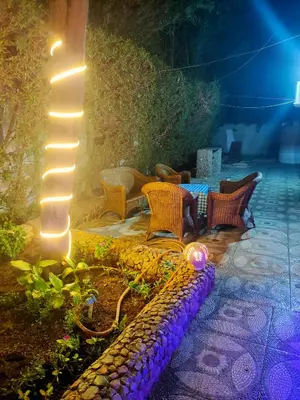 a bench with lights on a patio at night at Lux Gardenhouse pool WiFi Private garden Hurghada in Hurghada