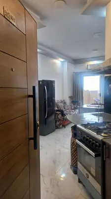 a kitchen with a refrigerator and a stove top oven at Juliana Beach Resort in Hurghada