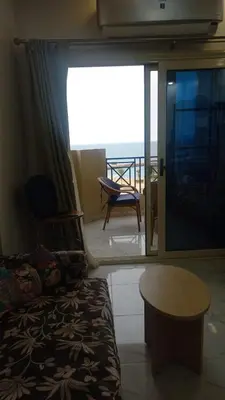 a room with a bed and a view of the ocean at Juliana Beach Resort in Hurghada