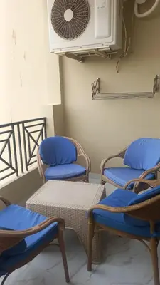 a room with three chairs and a fan at Juliana Beach Resort in Hurghada