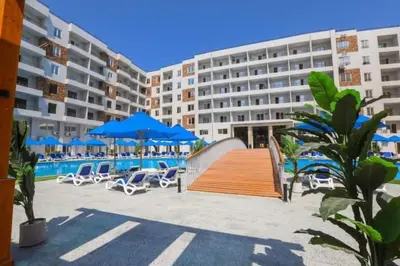 a hotel with chairs and umbrellas and a swimming pool at C'est la vie Golden in Hurghada