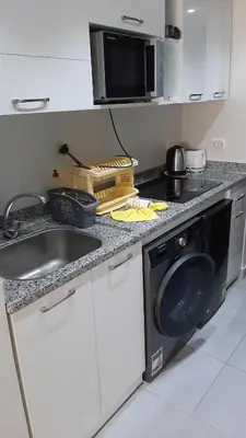 a kitchen with a sink and a washing machine at Hurghada Ägypten Scandic Resort in Hurghada