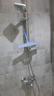 a blue toothbrush sitting on a stand in a shower at Hurghada Ägypten Scandic Resort in Hurghada