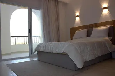 a bedroom with a large bed and a large window at Fully equipped studio Sahl Hasheesh in Hurghada